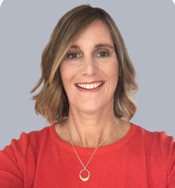 Liz Grennan smiling waering a red top